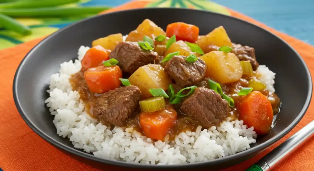 Hawaiian Beef Stew served over rice with tender beef, colorful vegetables in rich broth, garnished with green onions - authentic island comfort food