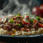 DIY Pepper Lunch: Restaurant Magic On Your Plate 11 Sizzling beef pepper lunch rice dish on a hot iron plate with melting butter and steam