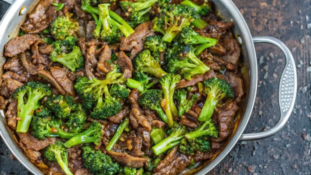 The Best Beef and Broccoli Recipe in One Pan 1 Close-up of beef and broccoli stir-fry in a stainless steel skillet