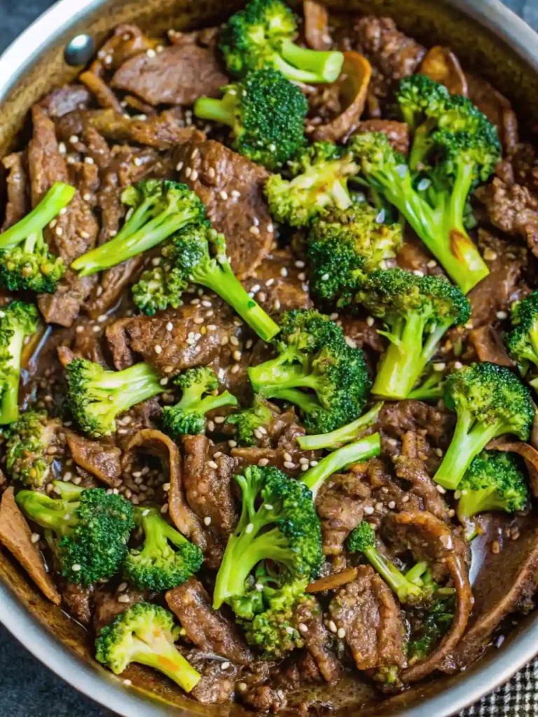 The Best Beef and Broccoli Recipe in One Pan 5 Beef and broccoli stir-fry topped with sesame seeds in a skillet