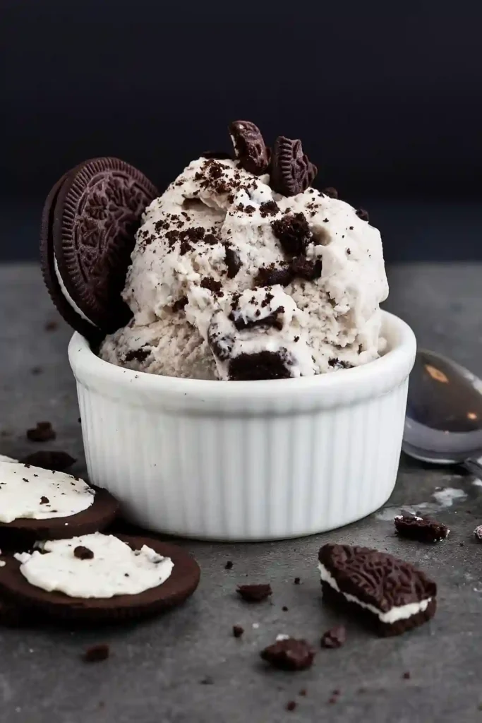 Cookies and Cream Ice Cream Recipe 6 Scoop of Cookies and Cream Ice Cream topped with cookie crumbles in a white ramekin
