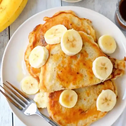 Brown Sugar Banana Pancakes 6 Plate of homemade Brown Sugar Banana Pancakes topped with banana slices