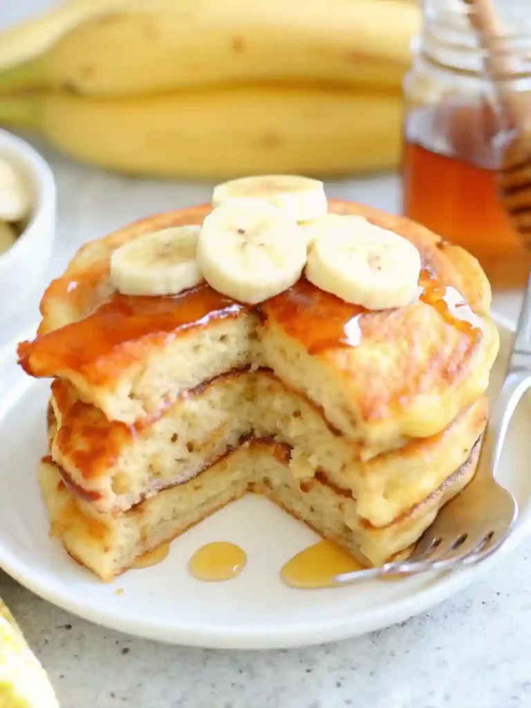 Brown Sugar Banana Pancakes 5 Fluffy Brown Sugar Banana Pancakes cut open and topped with bananas and syrup