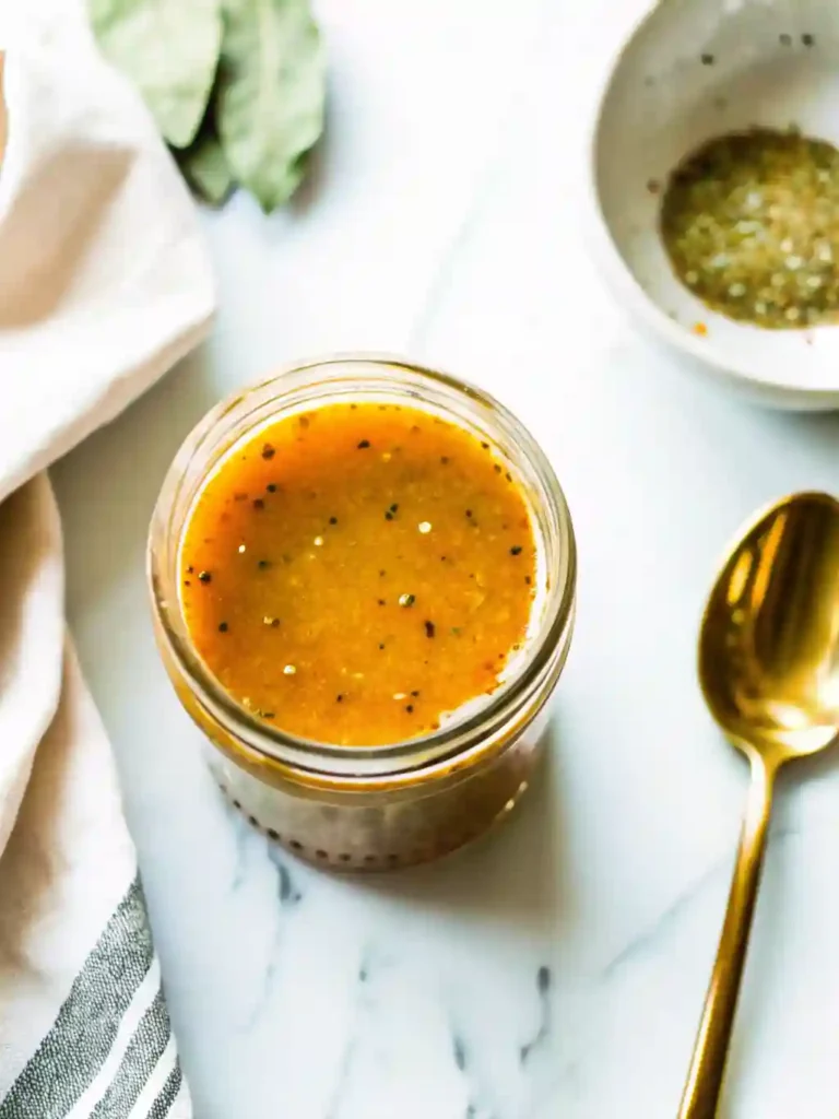 Easy Mediterranean Chickpea Salad Recipe Fresh and Quick 3 Jar of lemon vinaigrette used for Mediterranean chickpea salad on marble surface