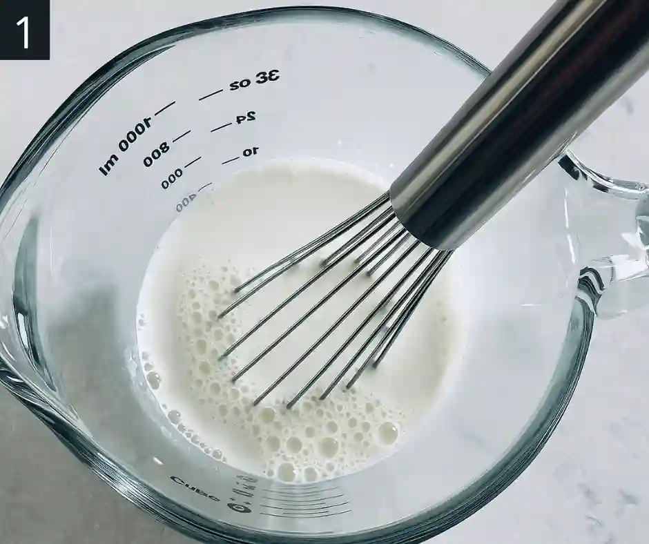 Cookies and Cream Ice Cream Recipe 2 Whisking milk and sugar in a glass bowl for Cookies and Cream Ice Cream
