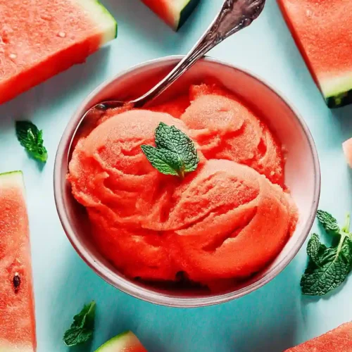 5-Minute Watermelon Sorbet 8 Bowl of watermelon sorbet with mint, surrounded by fresh watermelon slices