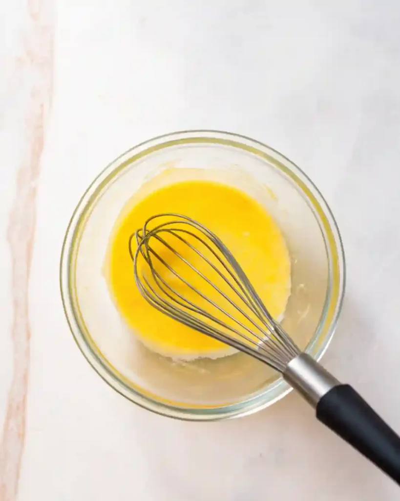 5-Star Pineapple Ice Cream Recipe You'll Crave 5 Whisk in a glass bowl with egg mixture for pineapple ice cream custard base