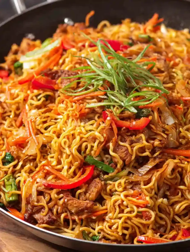 Chicken Vegetable Ramen Noodles Recipe 2 Chicken vegetable ramen noodles topped with sliced green onions and stir-fried vegetables in a skillet