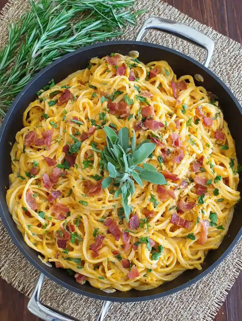 Butternut Squash Pasta Carbonara Recipe 2 Skillet filled with Butternut Squash Pasta Carbonara topped with bacon and fresh sage