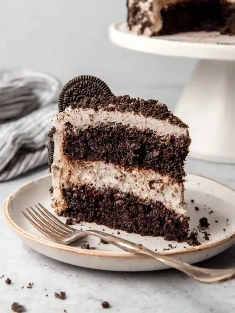 Irresistible Chocolate Oreo Cake Recipe 3 Chocolate Oreo Cake slice with Oreo frosting and cookie crumbs