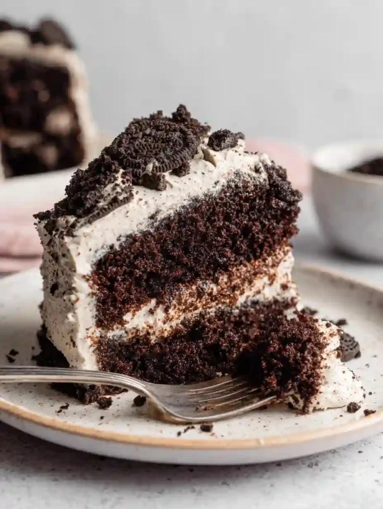 Irresistible Chocolate Oreo Cake Recipe 4 Chocolate Oreo Cake slice with Oreo crumbs and creamy frosting on a plate