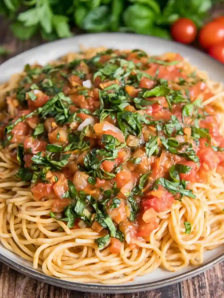 Cooked spaghetti served with Margherita sauce and chopped basil on top