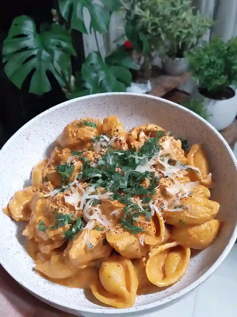 Cheesy Chicken Pasta Dinner Recipe 2 Bowl of cheesy chicken pasta topped with grated cheese, paprika, and fresh herbs