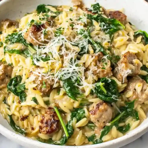 Ultimate Italian Sausage Orzo One Pot Bliss 4 Creamy Italian sausage orzo in a bowl with spinach and parmesan