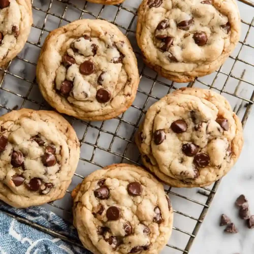 Best Chocolate Chip Cookie Recipe Ever 5 Chocolate chip cookie batch cooling on wire rack with golden edges and melted chips