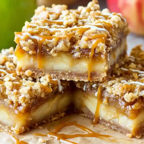 Salted Caramel Apple Pie Bars Recipe 5 Close-up of Salted Caramel Apple Pie Bars topped with golden crumble and caramel drizzle
