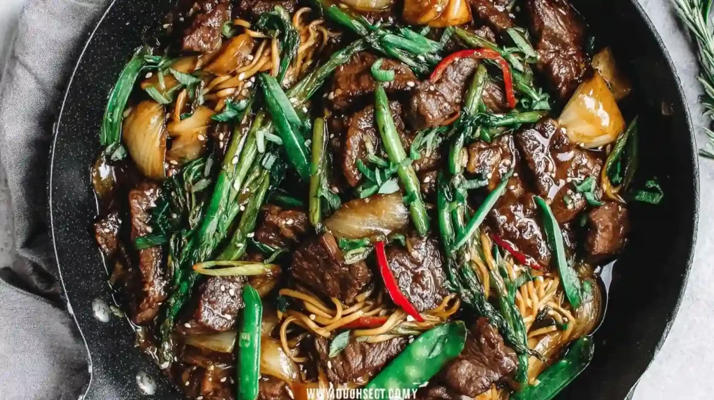 Beef with Oyster Sauce Recipe 1 Beef with Oyster Sauce stir fry with noodles, asparagus, onions, and sesame seeds in a skillet
