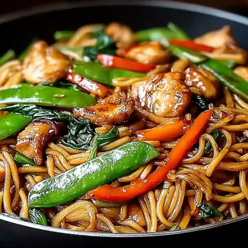 Chicken Lo Mein Recipe with noodles, chicken, and stir-fried vegetables in a bowl