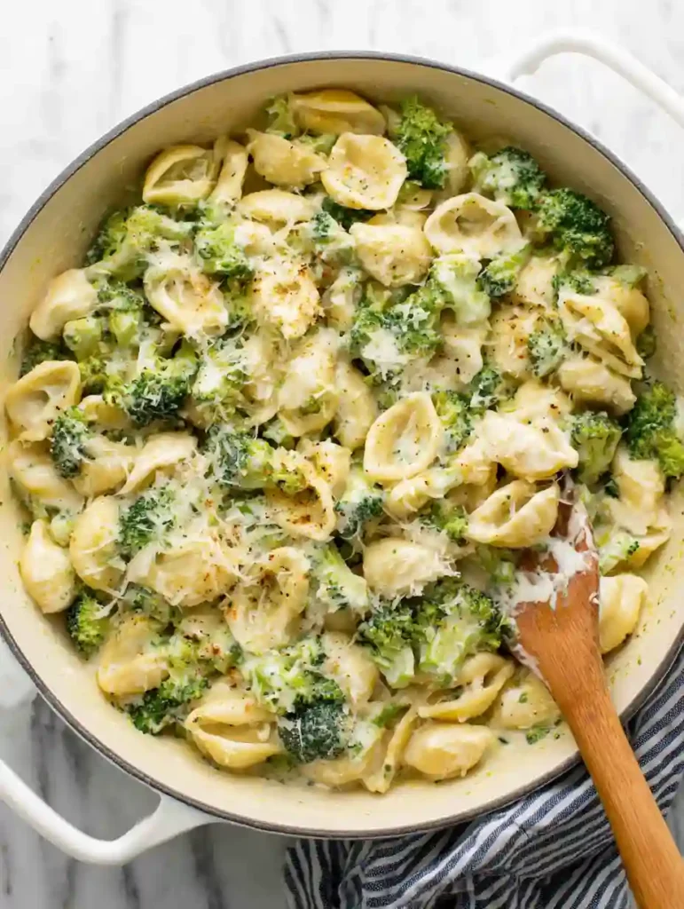Creamy Broccoli Pasta in a large pot with garlic Parmesan sauce and broccoli
