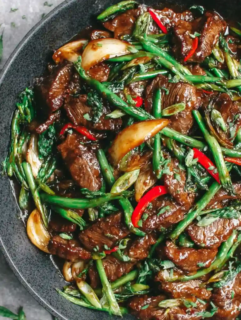 Beef with Oyster Sauce Recipe 3 Beef with Oyster Sauce stir fry featuring green beans, onions, and red chili in a dark sauce