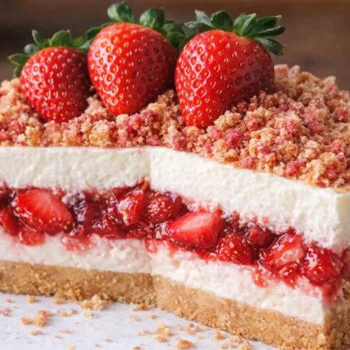 Strawberry Crunch Cheesecake with creamy layers, fresh strawberry filling, and crunchy cookie topping