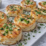 high-protein egg white bites on a platter topped with herbs and green onions