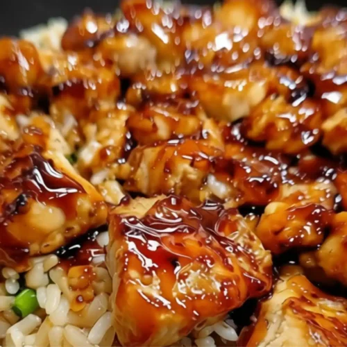 One-Pan Honey BBQ Chicken Rice served over fluffy white rice with glossy honey BBQ glazed chicken pieces