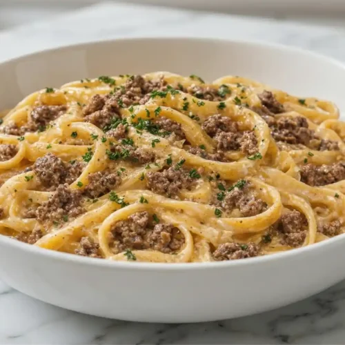 One-Pot Creamy Beef and Garlic Butter Pasta in a white bowl with parmesan sauce and ground beef