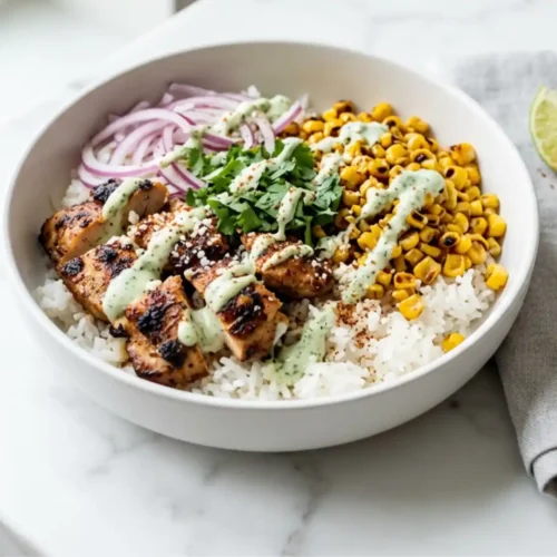 Street Corn Chicken Rice Bowl with grilled chicken, charred corn, rice, and cilantro lime sauce