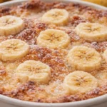Southern Banana Cobbler with sliced bananas and golden crust in a white baking dish