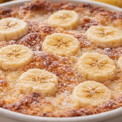 Southern Banana Cobbler with sliced bananas and golden crust in a white baking dish