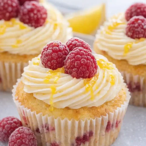 Lemon Raspberry Cupcakes topped with raspberry buttercream and fresh berries