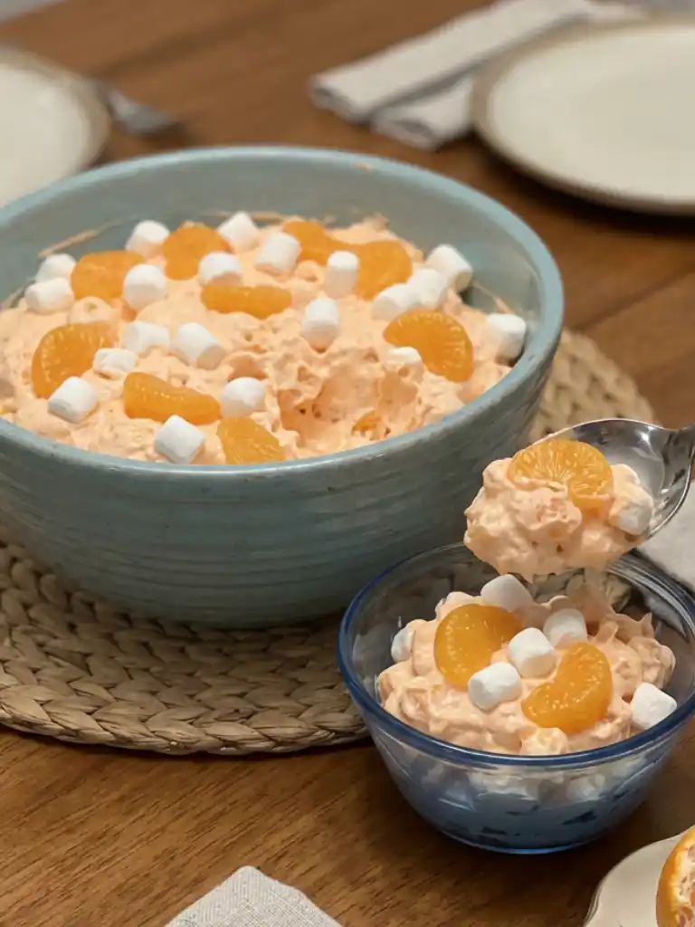 Orange Creamsicle Fluff Salad served in a bowl with mandarin oranges and mini marshmallows on top